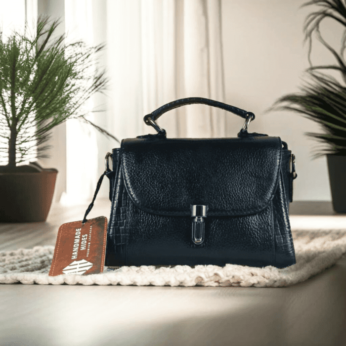 Elegant black leather handbag for women with a secure flap closure, adjustable detachable strap, and high-quality metal accents. Handmade from full-grain leather