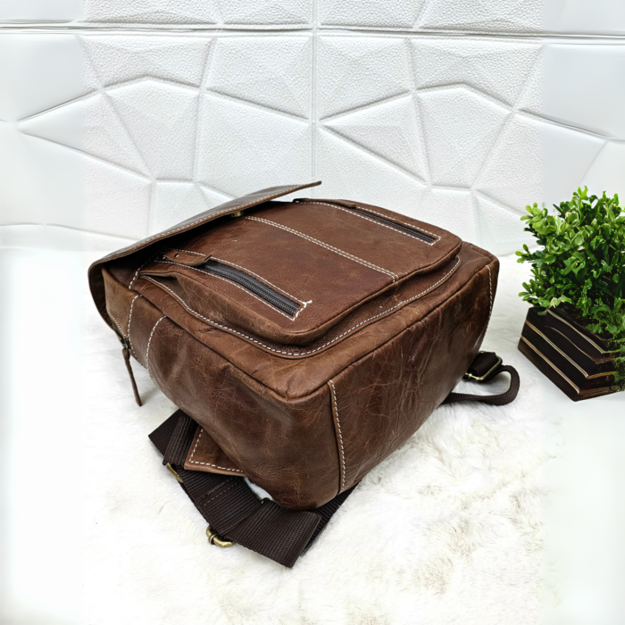 Full grain brown leather backpack with a stylish and minimalist design.