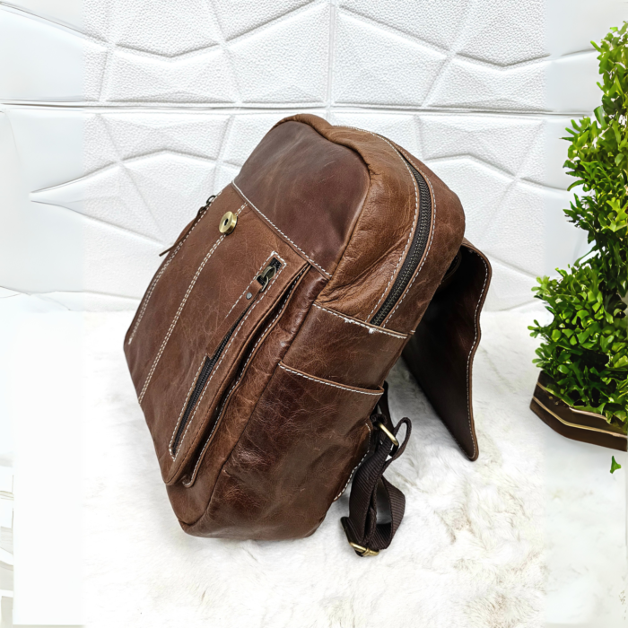 Full grain brown leather backpack with a stylish and minimalist design.
