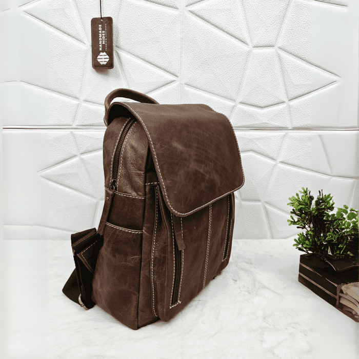 Full grain brown leather backpack with a stylish and minimalist design.