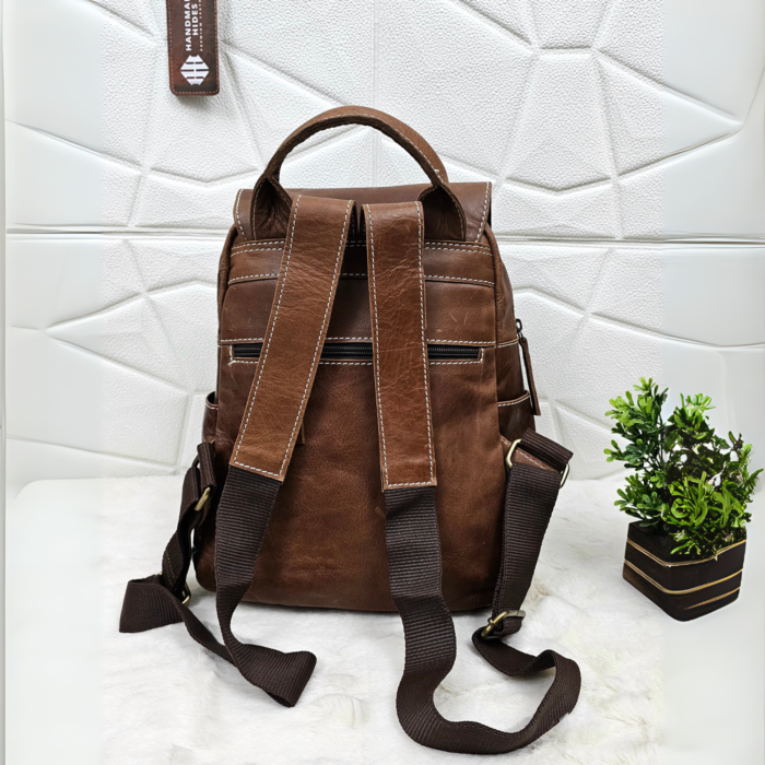 Full grain brown leather backpack with a stylish and minimalist design.