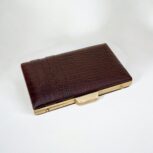Luxurious brown croc-embossed leather clutch with gold chain strap