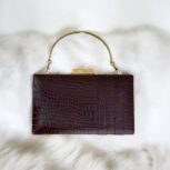 Luxurious brown croc-embossed leather clutch with gold chain strap