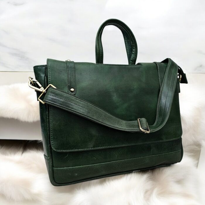Handmade Green Leather Laptop Bag displayed with office essentials
