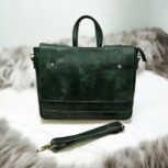 Handmade Green Leather Laptop Bag displayed with office essentials