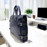 Premium handcrafted navy blue leather briefcase with adjustable shoulder strap and spacious compartments