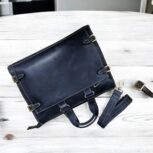Premium handcrafted navy blue leather briefcase with adjustable shoulder strap and spacious compartments