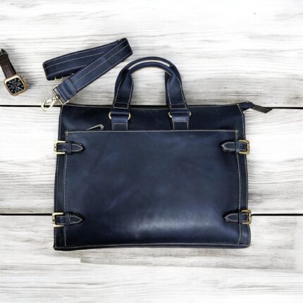 Premium handcrafted navy blue leather briefcase with adjustable shoulder strap and spacious compartments