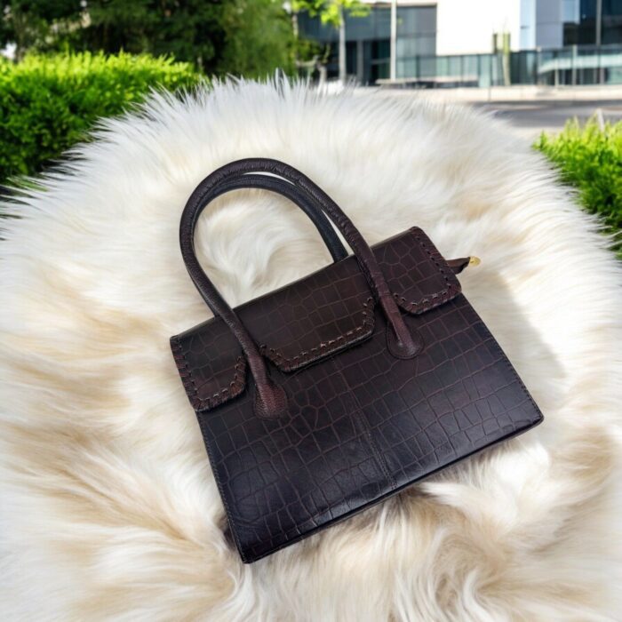 dark brown crocodile-embossed leather handbag with a structured silhouette.