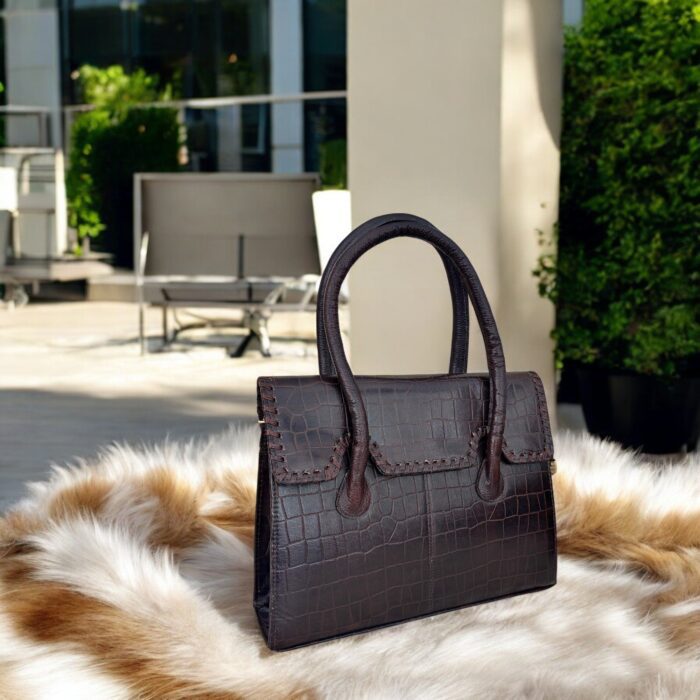 dark brown crocodile-embossed leather handbag with a structured silhouette.