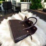 dark brown crocodile-embossed leather handbag with a structured silhouette.