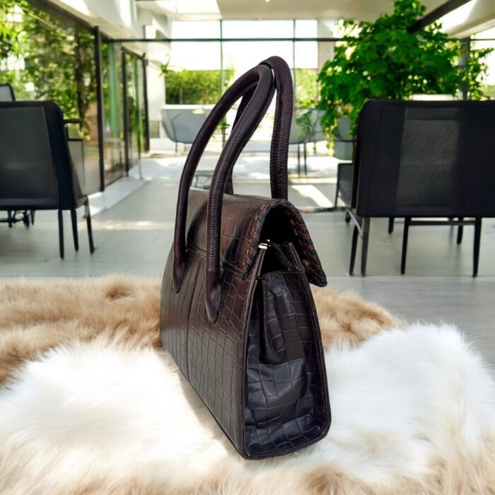 dark brown crocodile-embossed leather handbag with a structured silhouette.