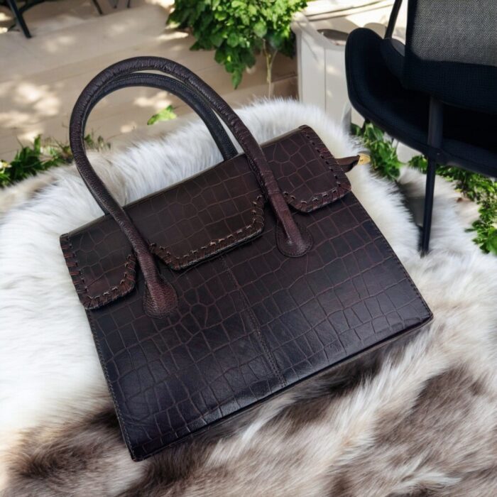 dark brown crocodile-embossed leather handbag with a structured silhouette.