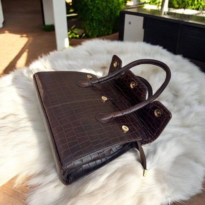 dark brown crocodile-embossed leather handbag with a structured silhouette.