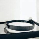 Black crocodile-embossed leather belt for men, luxury leather belt with polished metal buckle, premium croc-textured leather belt for formal and casual wear.
