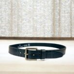 Black crocodile-embossed leather belt for men, luxury leather belt with polished metal buckle, premium croc-textured leather belt for formal and casual wear.