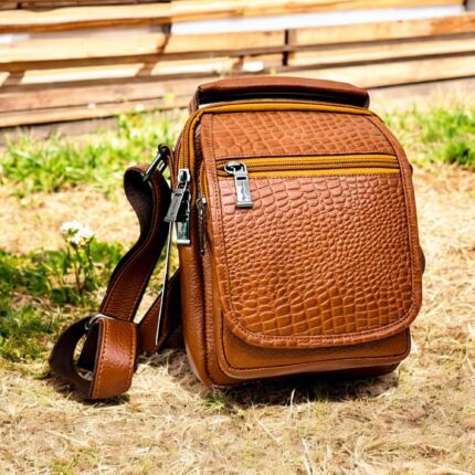 Handmade crocodile-embossed leather crossbody bag with a rich brown finish, adjustable strap, and multiple compartments for everyday essentials.
