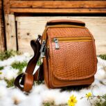 Handmade crocodile-embossed leather crossbody bag with a rich brown finish, adjustable strap, and multiple compartments for everyday essentials.