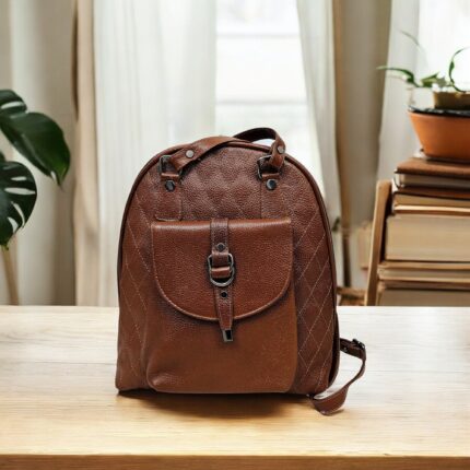 Handmade brown leather backpack with quilted stitching and a front buckle pocket