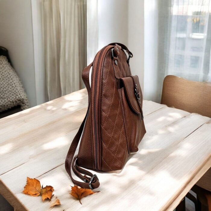 Handmade brown leather backpack with quilted stitching and a front buckle pocket