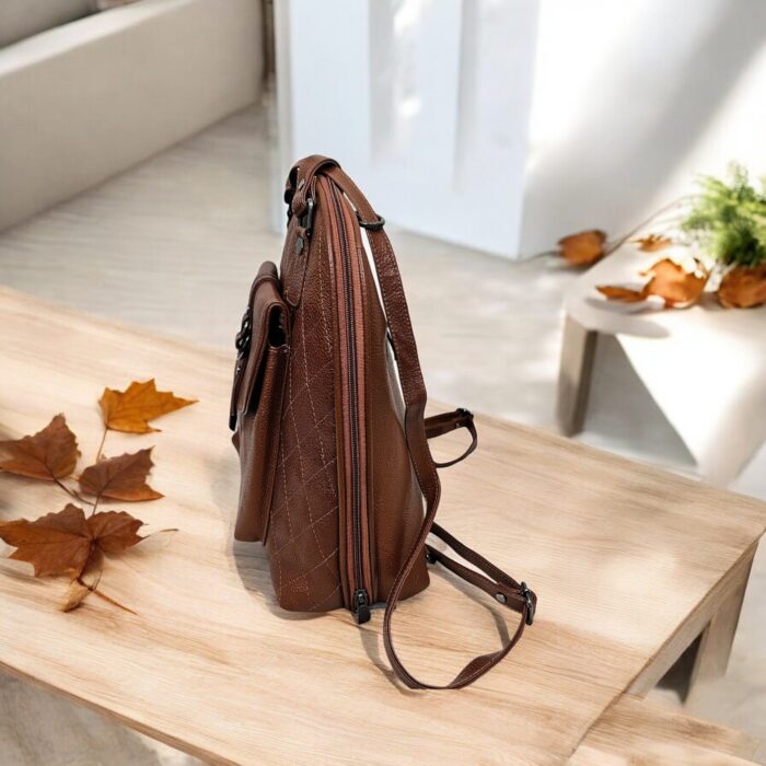 Handmade brown leather backpack with quilted stitching and a front buckle pocket