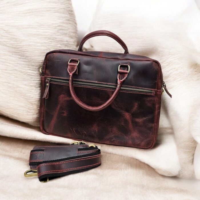 Premium full-grain leather laptop bag for professionals, handcrafted with spacious compartments, durable metal zippers, and adjustable strap for versatile carry