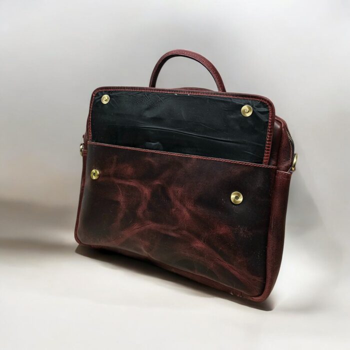 Premium full-grain leather laptop bag for professionals, handcrafted with spacious compartments, durable metal zippers, and adjustable strap for versatile carry
