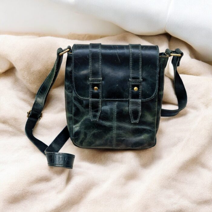 Handcrafted genuine leather sling bag made from ethically sourced goat leather. Compact yet spacious crossbody bag with zippered pockets and adjustable strap. Unisex design, perfect for work, travel, or everyday use. Durable, stylish, and eco-friendly.