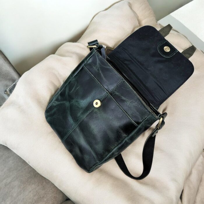 Handcrafted genuine leather sling bag made from ethically sourced goat leather. Compact yet spacious crossbody bag with zippered pockets and adjustable strap. Unisex design, perfect for work, travel, or everyday use. Durable, stylish, and eco-friendly.