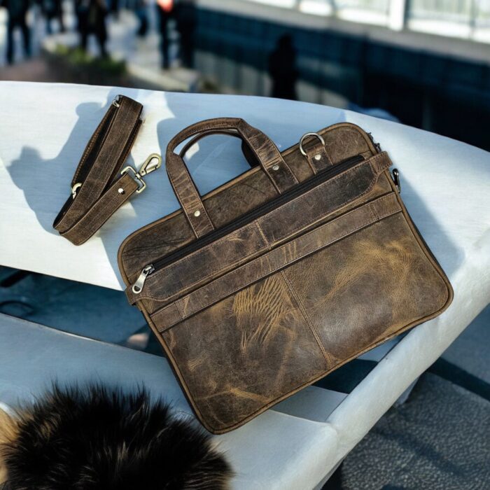 Spacious dark brown leather briefcase with a detachable shoulder strap and top handle