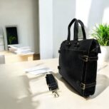 Premium black leather laptop bag with a sleek, professional design for business and travel.
