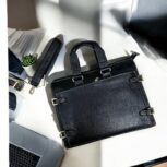 Premium black leather laptop bag with a sleek, professional design for business and travel.