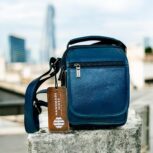 Handmade crocodile-embossed blue leather crossbody bag with an adjustable strap, multiple compartments, and a secure closure for everyday essentials