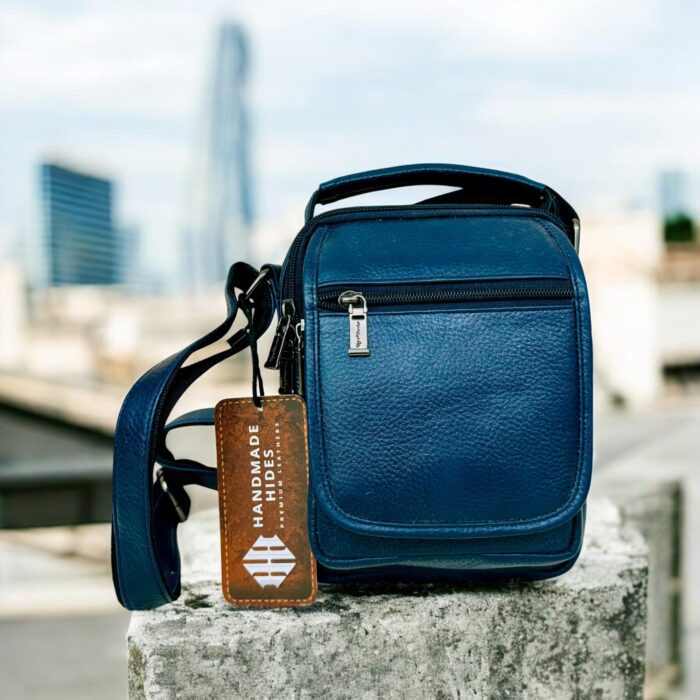 Handmade crocodile-embossed blue leather crossbody bag with an adjustable strap, multiple compartments, and a secure closure for everyday essentials