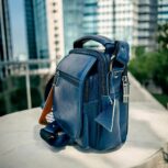 Handmade crocodile-embossed blue leather crossbody bag with an adjustable strap, multiple compartments, and a secure closure for everyday essentials