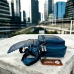 Handmade crocodile-embossed blue leather crossbody bag with an adjustable strap, multiple compartments, and a secure closure for everyday essentials