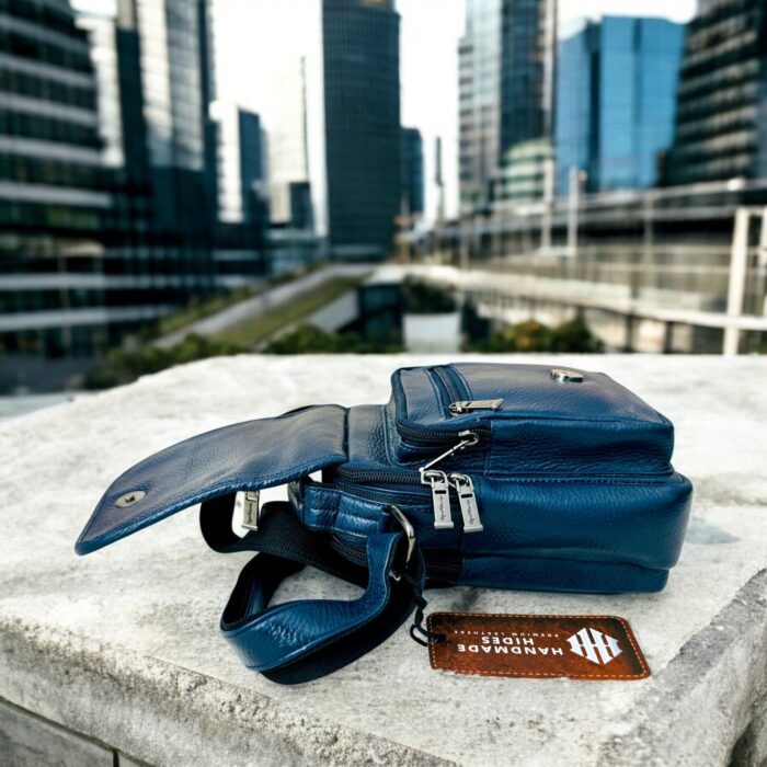 Handmade crocodile-embossed blue leather crossbody bag with an adjustable strap, multiple compartments, and a secure closure for everyday essentials