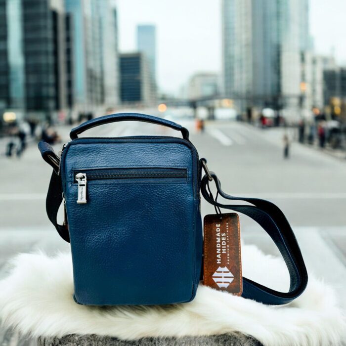 Handmade crocodile-embossed blue leather crossbody bag with an adjustable strap, multiple compartments, and a secure closure for everyday essentials