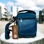 Handmade crocodile-embossed blue leather crossbody bag with an adjustable strap, multiple compartments, and a secure closure for everyday essentials