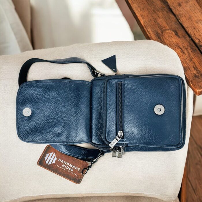 Handmade crocodile-embossed blue leather crossbody bag with an adjustable strap, multiple compartments, and a secure closure for everyday essentials