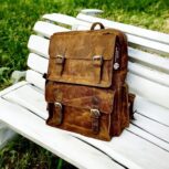 Handmade genuine leather backpack in a vintage brown finish, featuring adjustable straps and premium craftsmanship