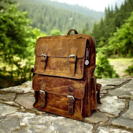 Handmade genuine leather backpack in a vintage brown finish, featuring adjustable straps and premium craftsmanship