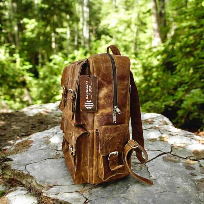 Handmade genuine leather backpack in a vintage brown finish, featuring adjustable straps and premium craftsmanship