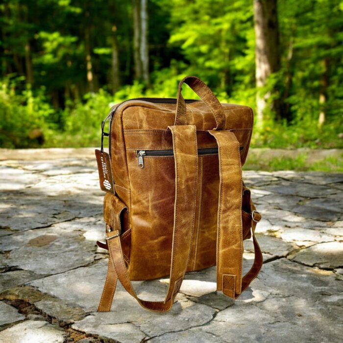 Handmade genuine leather backpack in a vintage brown finish, featuring adjustable straps and premium craftsmanship