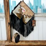 Luxury hair-on leather crossbody bag with tooled leather accents and fringe details