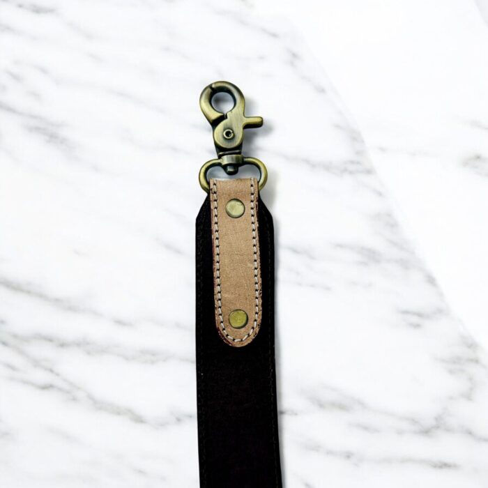 Luxury hair-on leather crossbody bag with tooled leather accents and fringe details