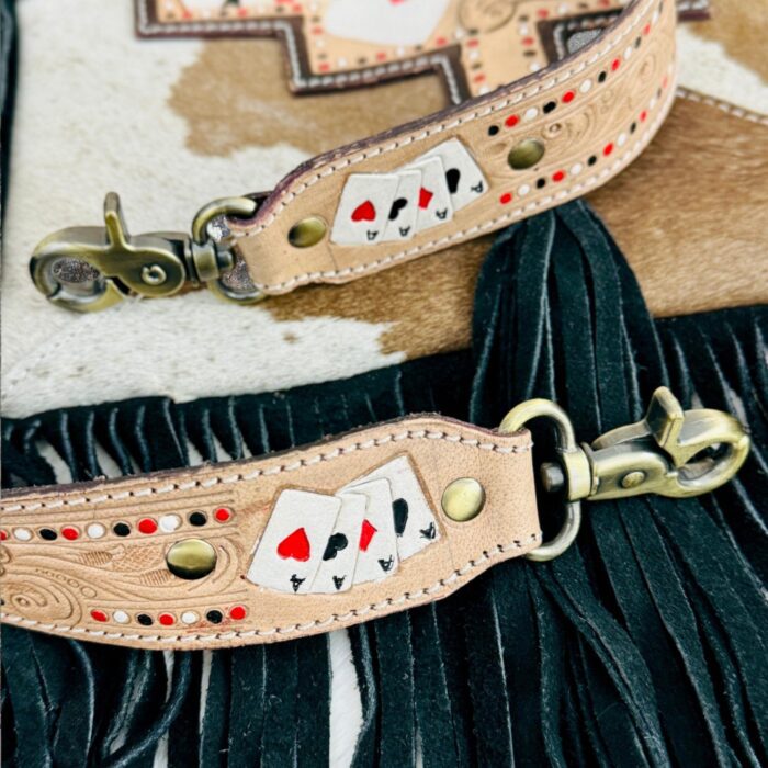 Luxury hair-on leather crossbody bag with tooled leather accents and fringe details