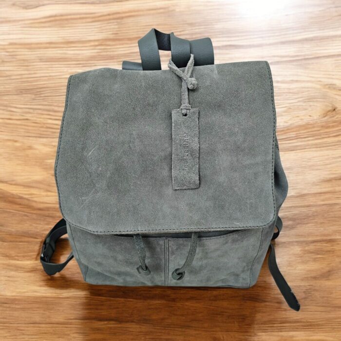 Premium handmade grey leather backpack with spacious compartments, adjustable strap, and multiple pockets. Perfect for work, travel, or daily use.