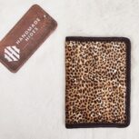 Hair-on-hide leather passport holder open with cards