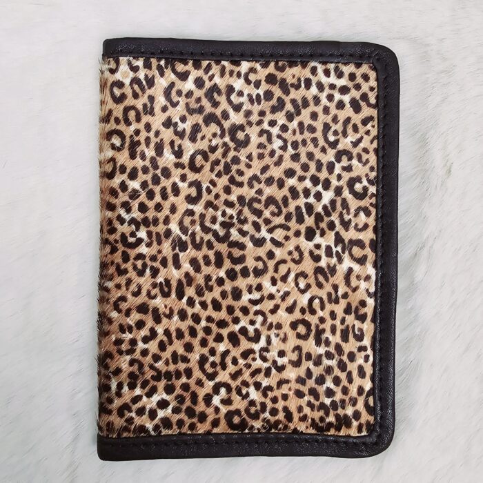Hair-on-hide leather passport holder open with cards